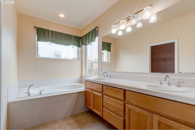 bathroom featuring vanity, tiled bath, and tile patterned floors