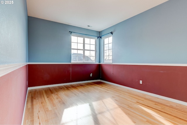 unfurnished room with hardwood / wood-style floors