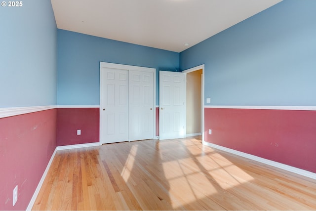 unfurnished bedroom featuring hardwood / wood-style flooring and a closet