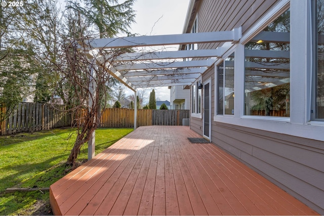 deck with a pergola and a lawn