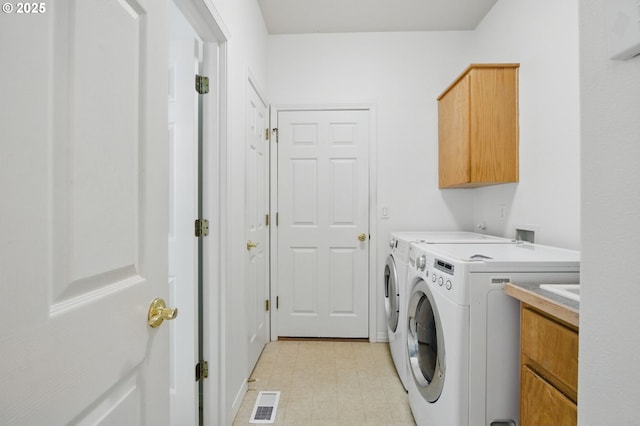 5306 NW Skycrest Pkwy, Portland, OR 97229 - clothes washing area with cabinet space, visible vents, light floors, and separate washer and dryer