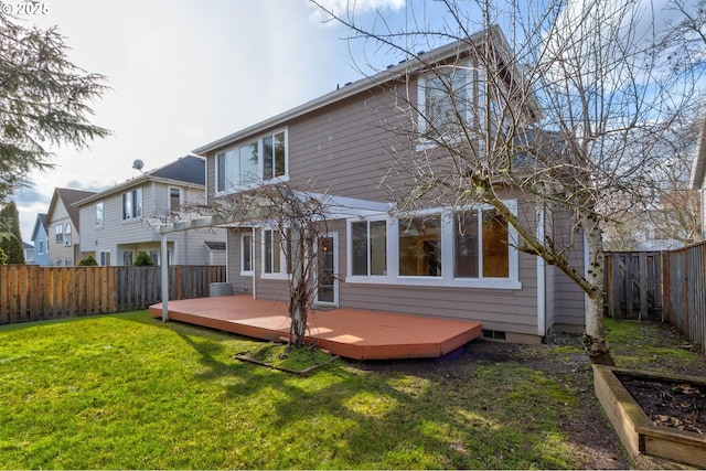 rear view of property featuring a wooden deck and a lawn