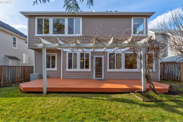 rear view of house with a wooden deck, a pergola, a lawn, and central AC unit