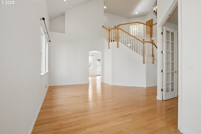 5306 NW Skycrest Pkwy, Portland, OR 97229 - interior space with arched walkways, baseboards, recessed lighting, a high ceiling, and wood finished floors