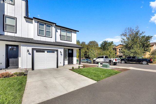 view of front of home with a garage and a front lawn