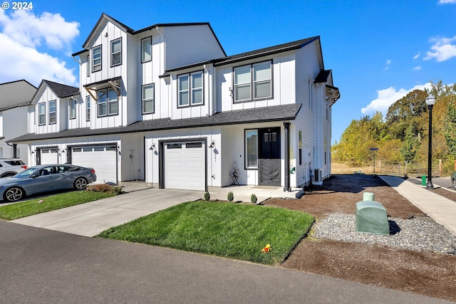 view of front of house featuring a front yard and a garage