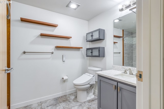 bathroom with toilet, tile floors, and large vanity