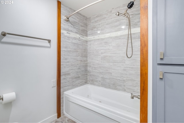 bathroom featuring tiled shower / bath combo and tile flooring