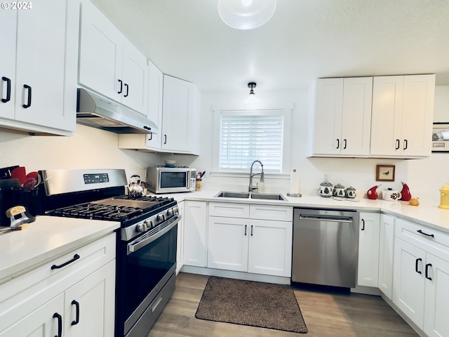 kitchen featuring sink, stainless steel appliances, and white cabinets