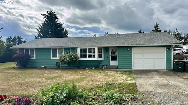 single story home with a garage and a front lawn