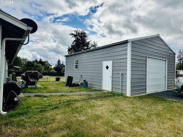 garage featuring a lawn