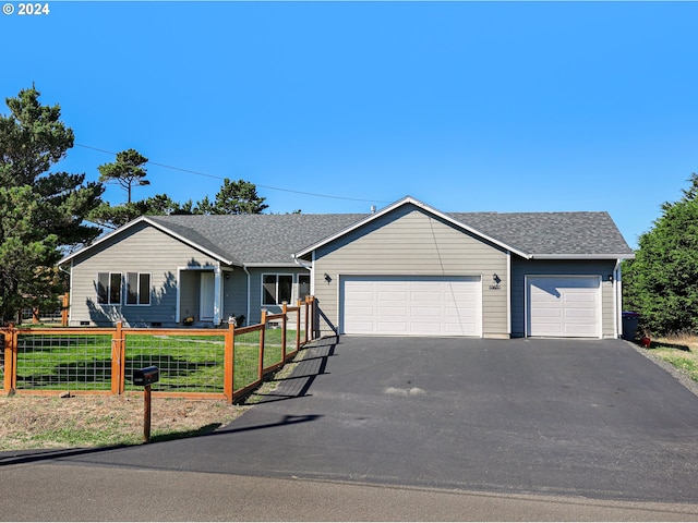 single story home featuring a front lawn and a garage