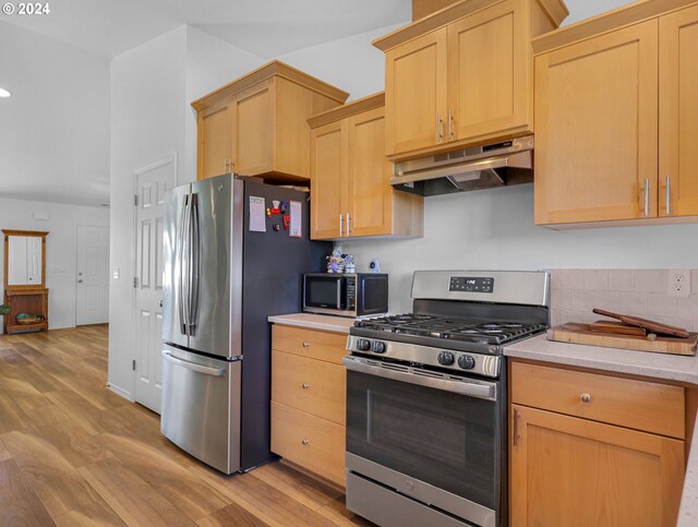 kitchen with light wood-type flooring, light brown cabinetry, and stainless steel appliances