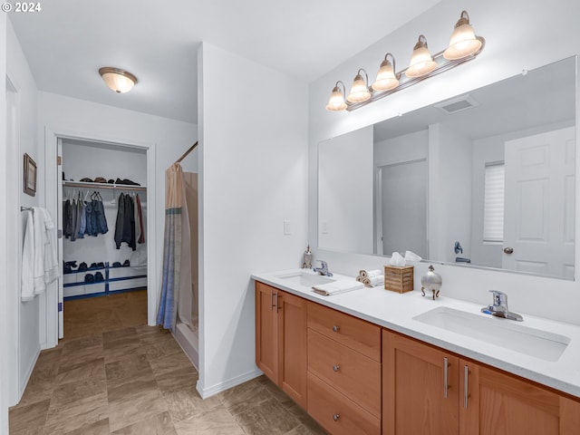 bathroom with walk in shower and vanity