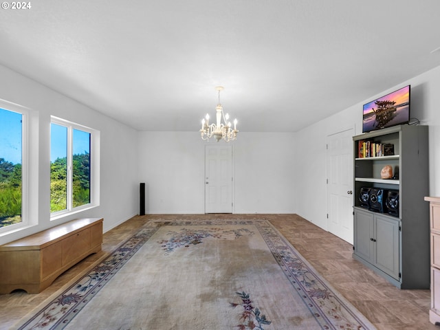 unfurnished room featuring an inviting chandelier