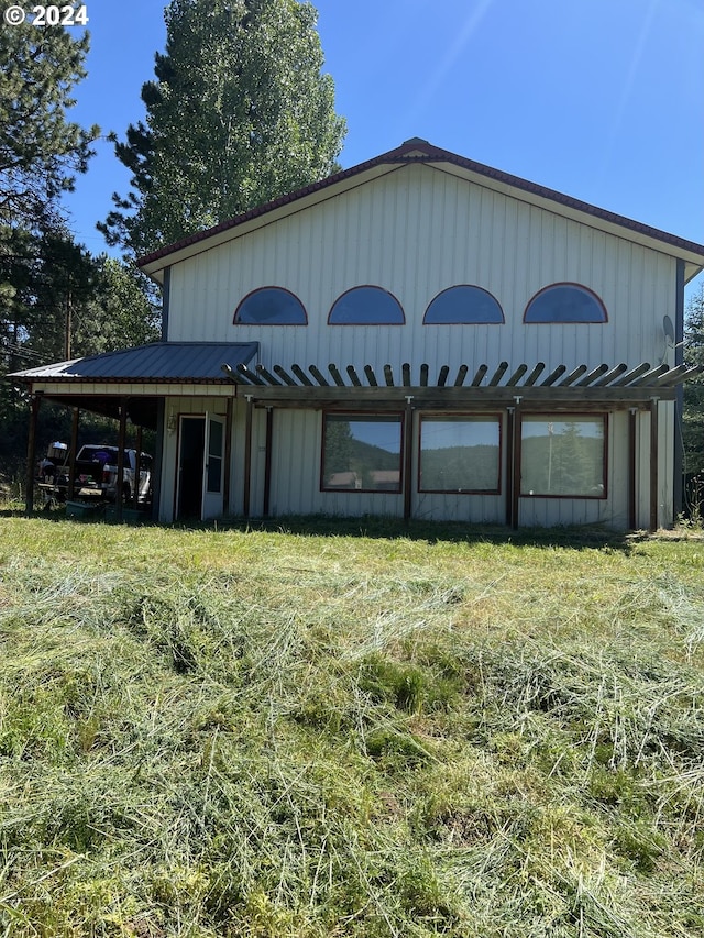 exterior space with metal roof and an attached carport