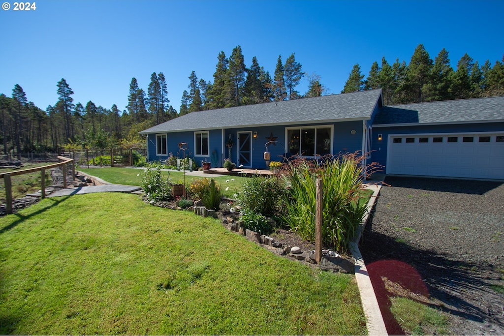 single story home featuring a garage and a front yard