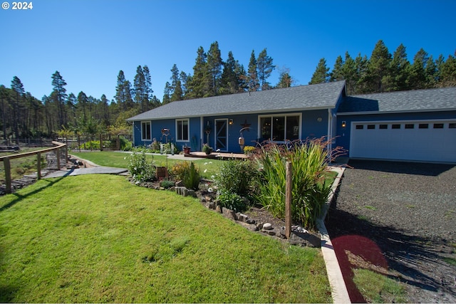 single story home featuring a garage and a front yard