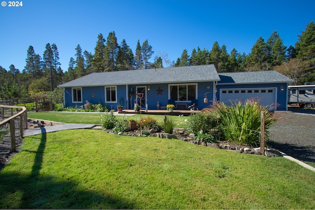 single story home with a porch, a garage, and a front yard