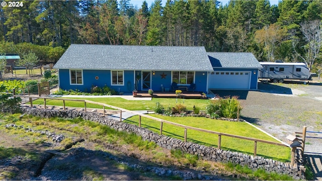 ranch-style house featuring a garage and a front lawn