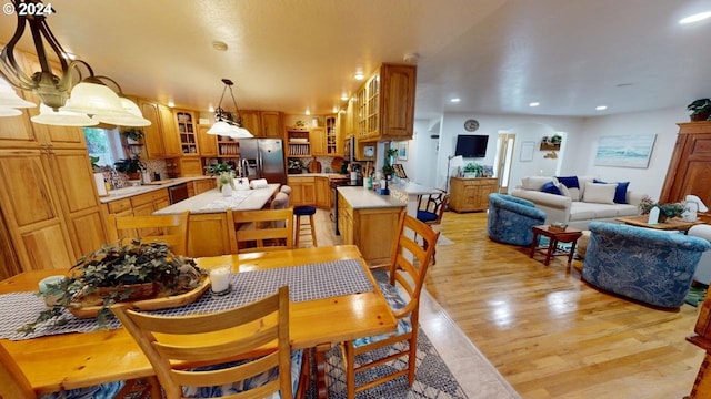 dining area with recessed lighting and light wood-style floors