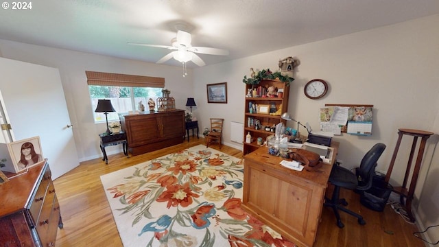 office space with light wood finished floors and ceiling fan