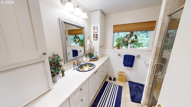 full bath with wainscoting, a healthy amount of sunlight, a stall shower, and vanity