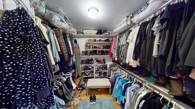 walk in closet featuring wood finished floors