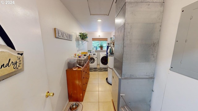 corridor featuring washer and dryer, electric panel, and light tile patterned floors