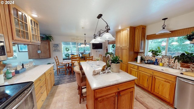 kitchen with backsplash, a center island, glass insert cabinets, stainless steel appliances, and a sink