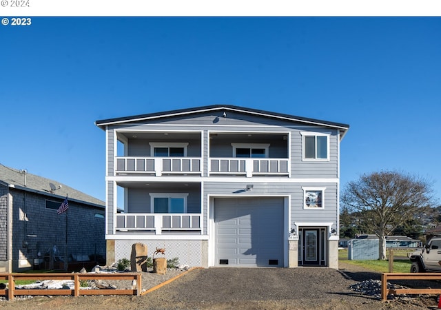 view of front of house with a garage and a balcony