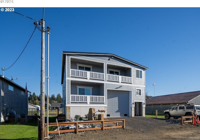 35165 Rueppell Ave, Pacific City, OR 97135 - view of front of house with a balcony, a garage, and dirt driveway