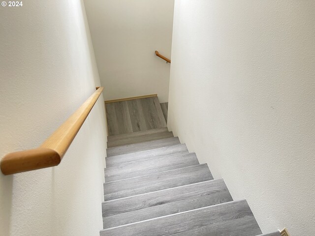 staircase with hardwood / wood-style flooring