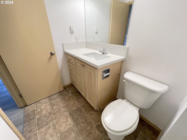 bathroom featuring tile patterned flooring, vanity, and toilet