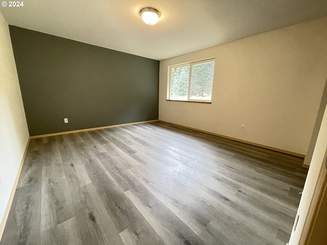 unfurnished room with hardwood / wood-style floors