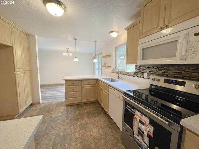 kitchen featuring tasteful backsplash, light countertops, light brown cabinetry, a sink, and white appliances