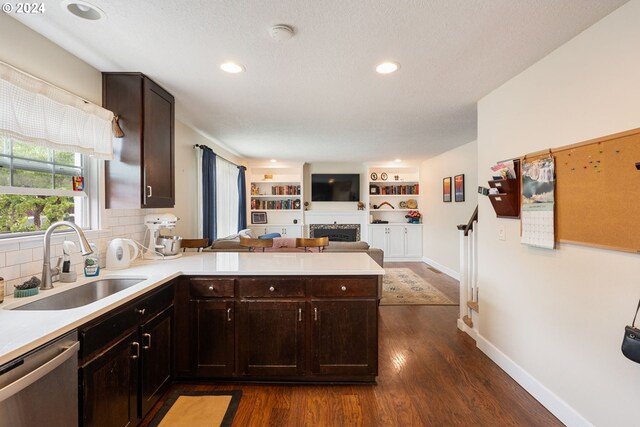 kitchen with dishwasher, backsplash, sink, dark wood-type flooring, and kitchen peninsula