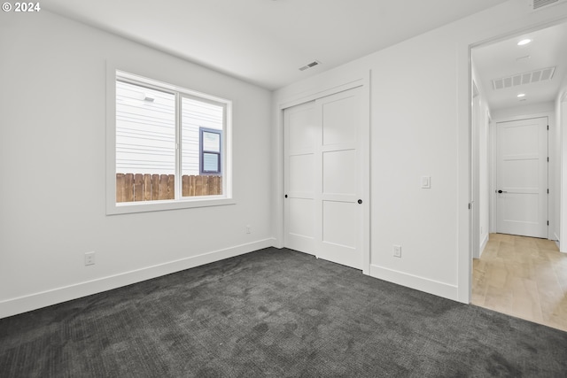 unfurnished bedroom featuring hardwood / wood-style flooring and a closet