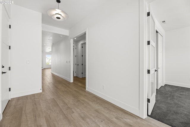 hallway with wood-type flooring