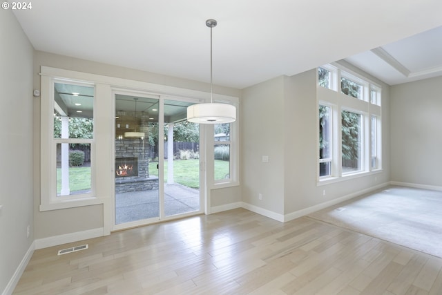 entryway featuring a fireplace and light hardwood / wood-style floors