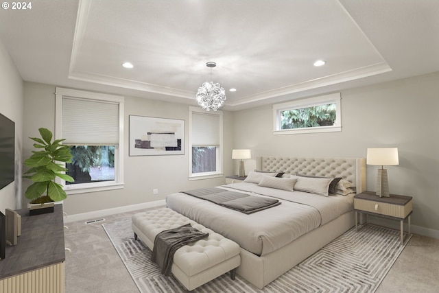 carpeted bedroom with a tray ceiling and a chandelier