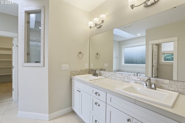 bathroom featuring vanity, tasteful backsplash, and tile patterned flooring