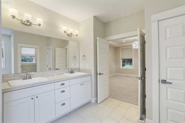 bathroom with vanity, decorative backsplash, and tile patterned floors