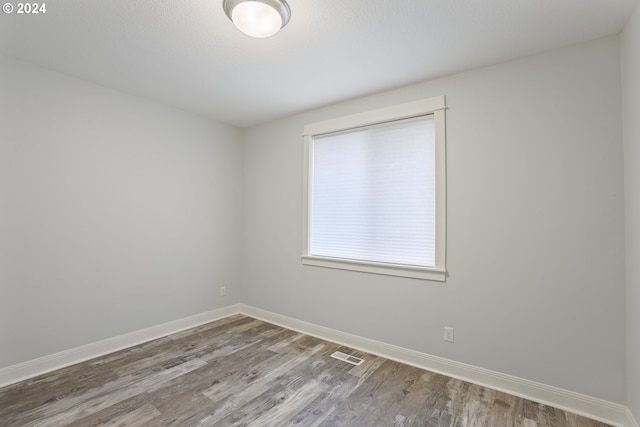 unfurnished room with wood-type flooring