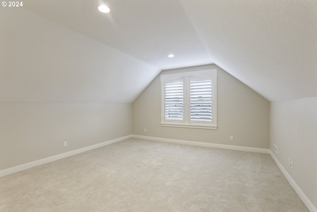 bonus room with carpet and vaulted ceiling