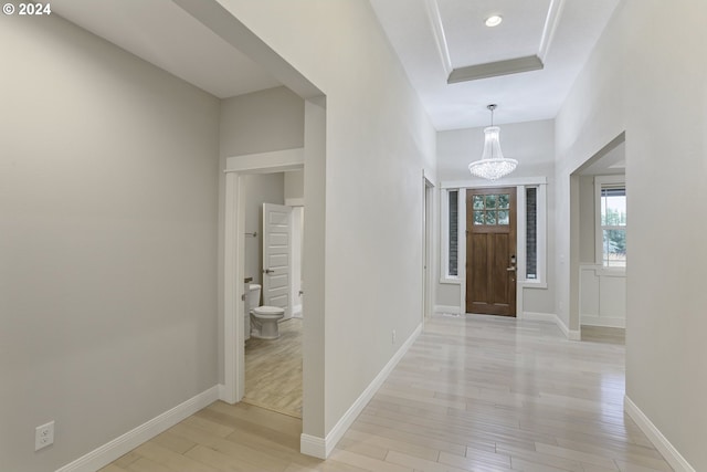 foyer entrance with a chandelier and light hardwood / wood-style flooring