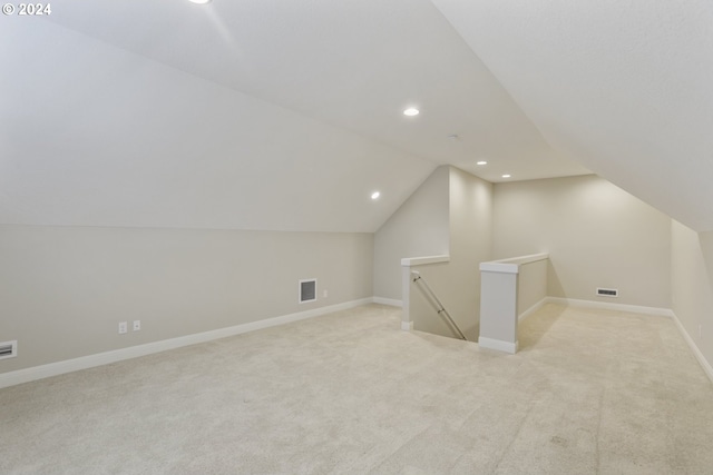 additional living space with lofted ceiling and light colored carpet