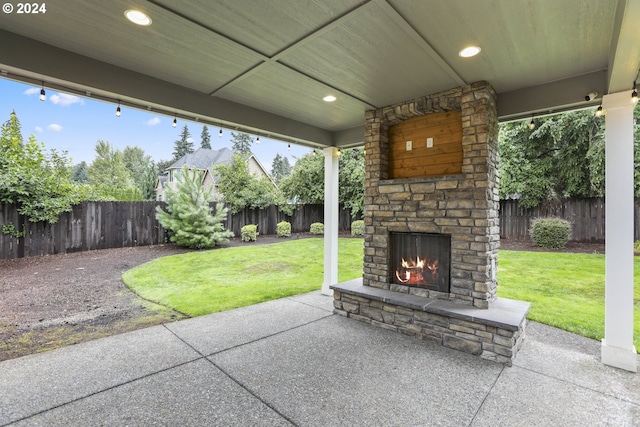 view of patio / terrace featuring an outdoor stone fireplace