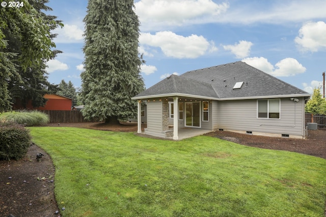 rear view of house featuring a yard and a patio