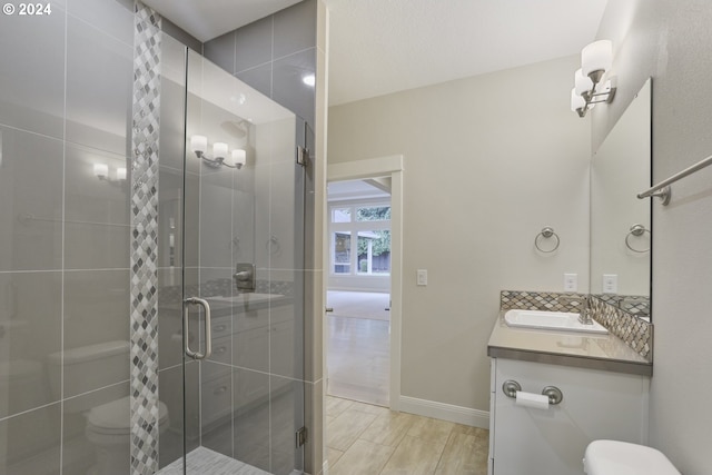 bathroom featuring vanity, toilet, hardwood / wood-style floors, and an enclosed shower